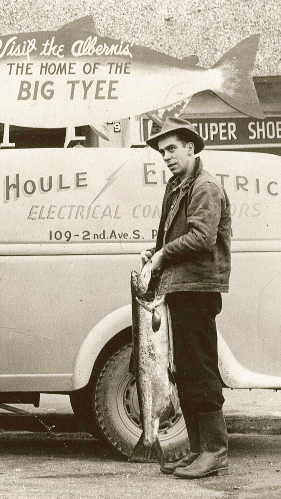 Lionel Houle in 1944 standing in front of a Houle Electric van.