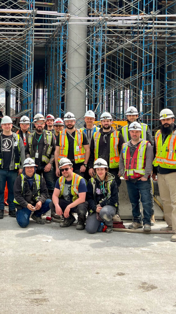 A few of the 1000 Houle employees stood in front of a construction site.