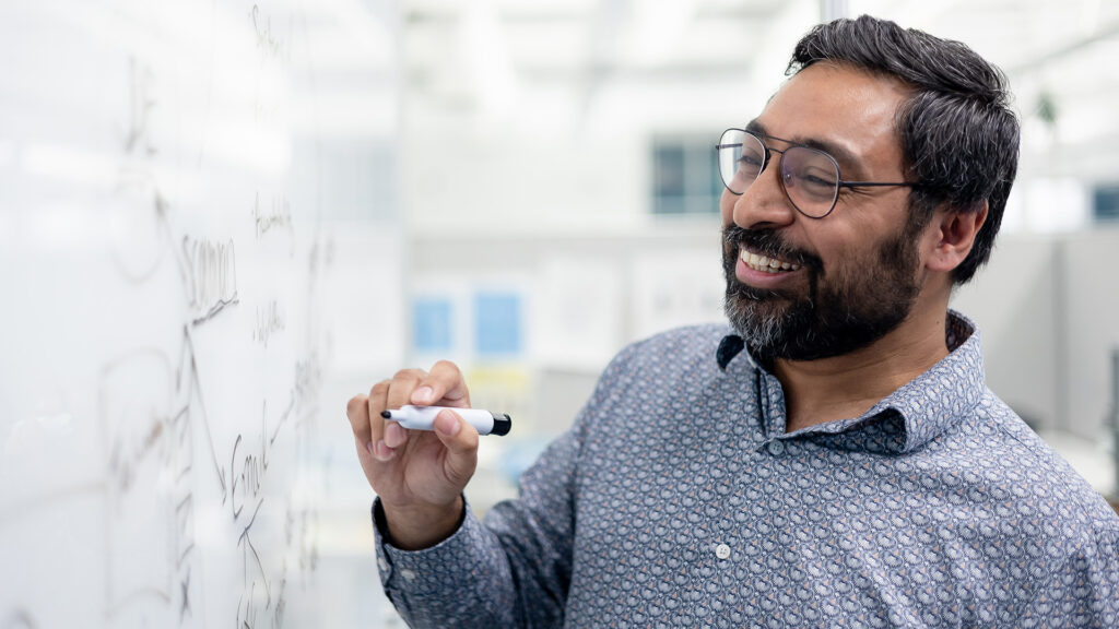 A Houle team member planning a project on a whiteboard