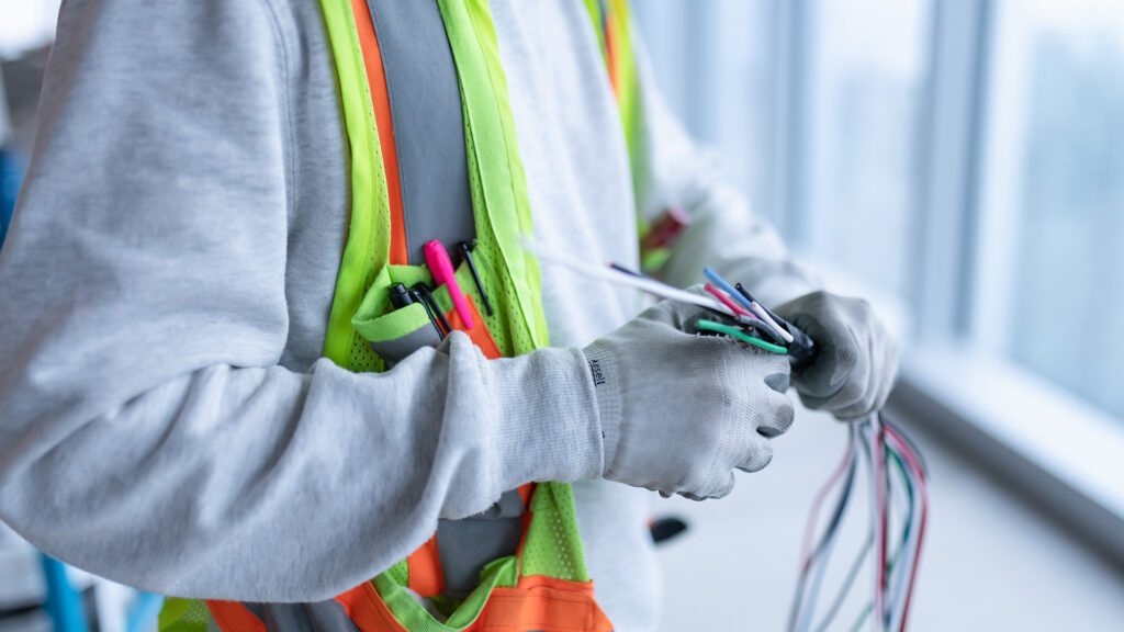 Apprentice preparing electrical wires.