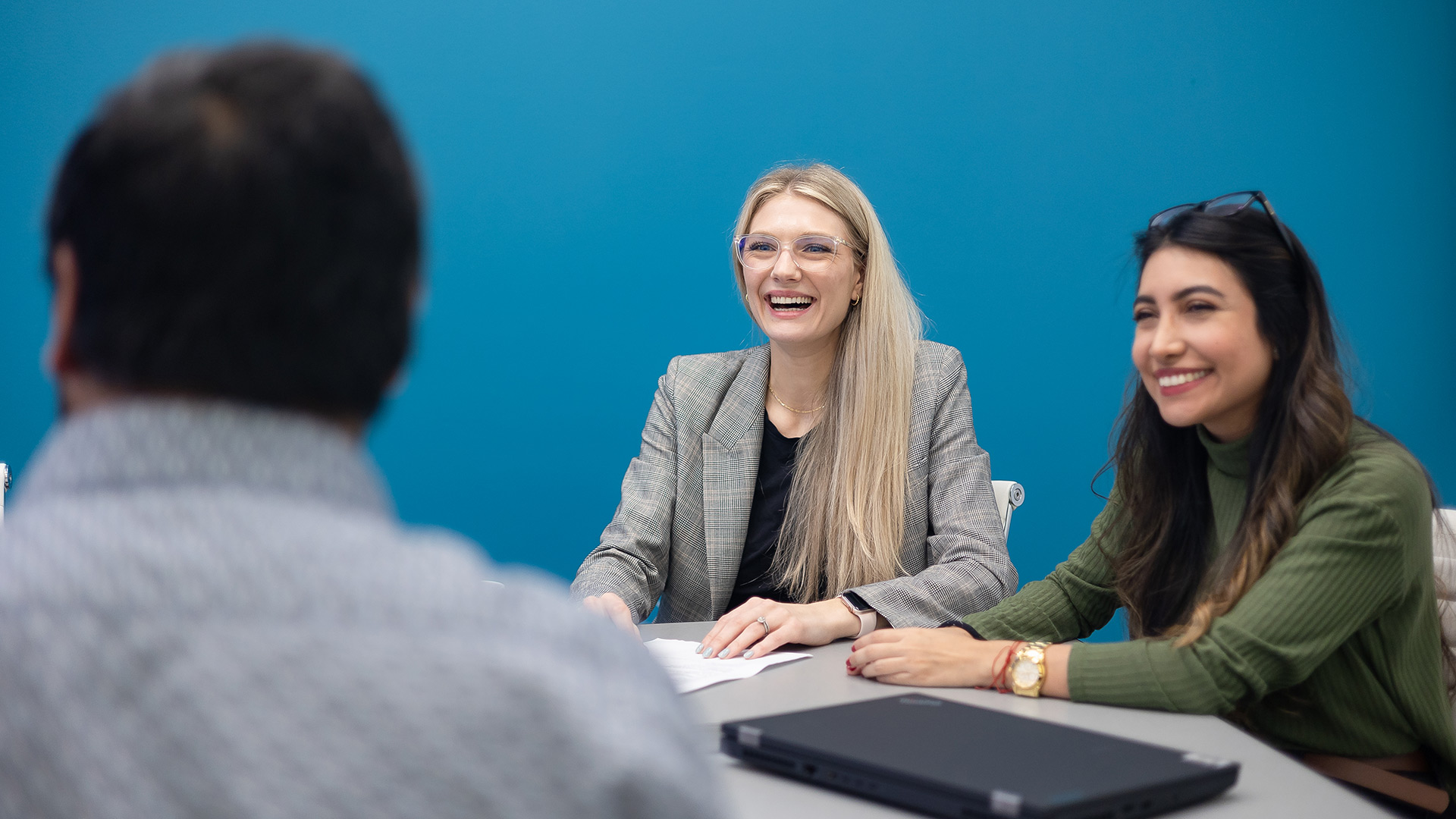 Office workers collaborating together, smiling.