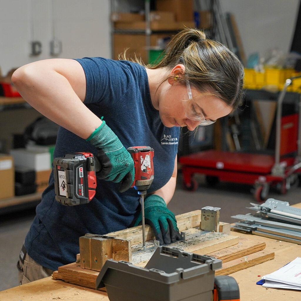 Prefab apprentice preparing a prefabricated electrical assembly. 