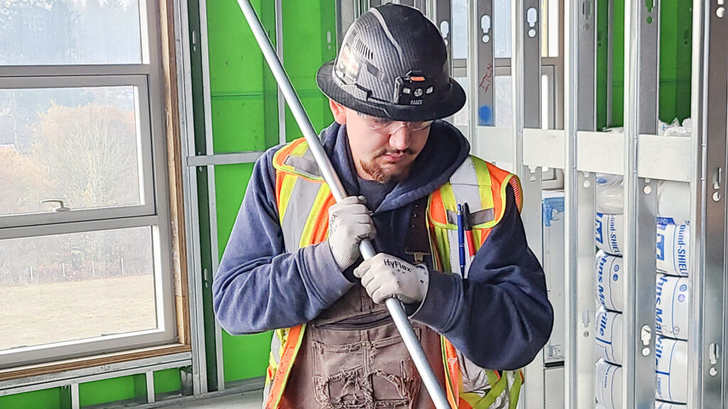 WATT Program apprentice bending conduit for electrical installation.